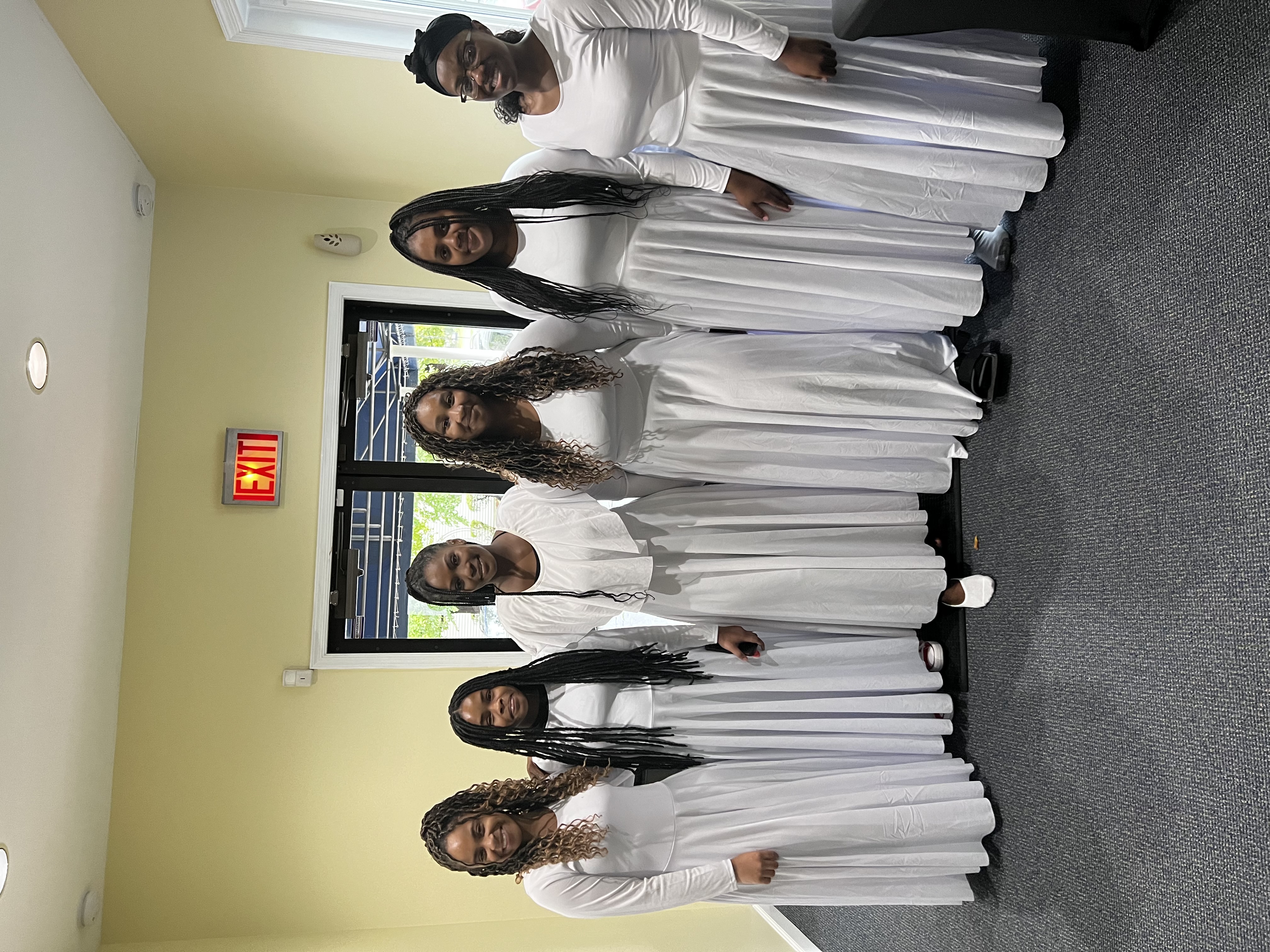 Members of Trinity Divine Dance Ministry gathered in coordinated white worship attire